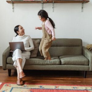 Mãe e filha em ambiente doméstico durante consulta pediátrica on-line